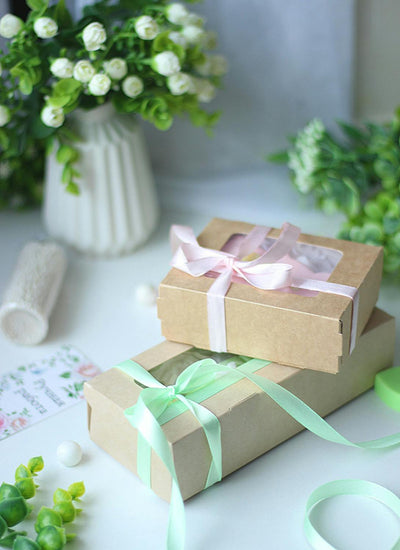 Beautiful gift boxes with pastel ribbons for girls clothing gift guide