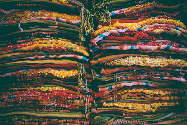 Folded and stacked natural cotton fabric in soft neutral tones