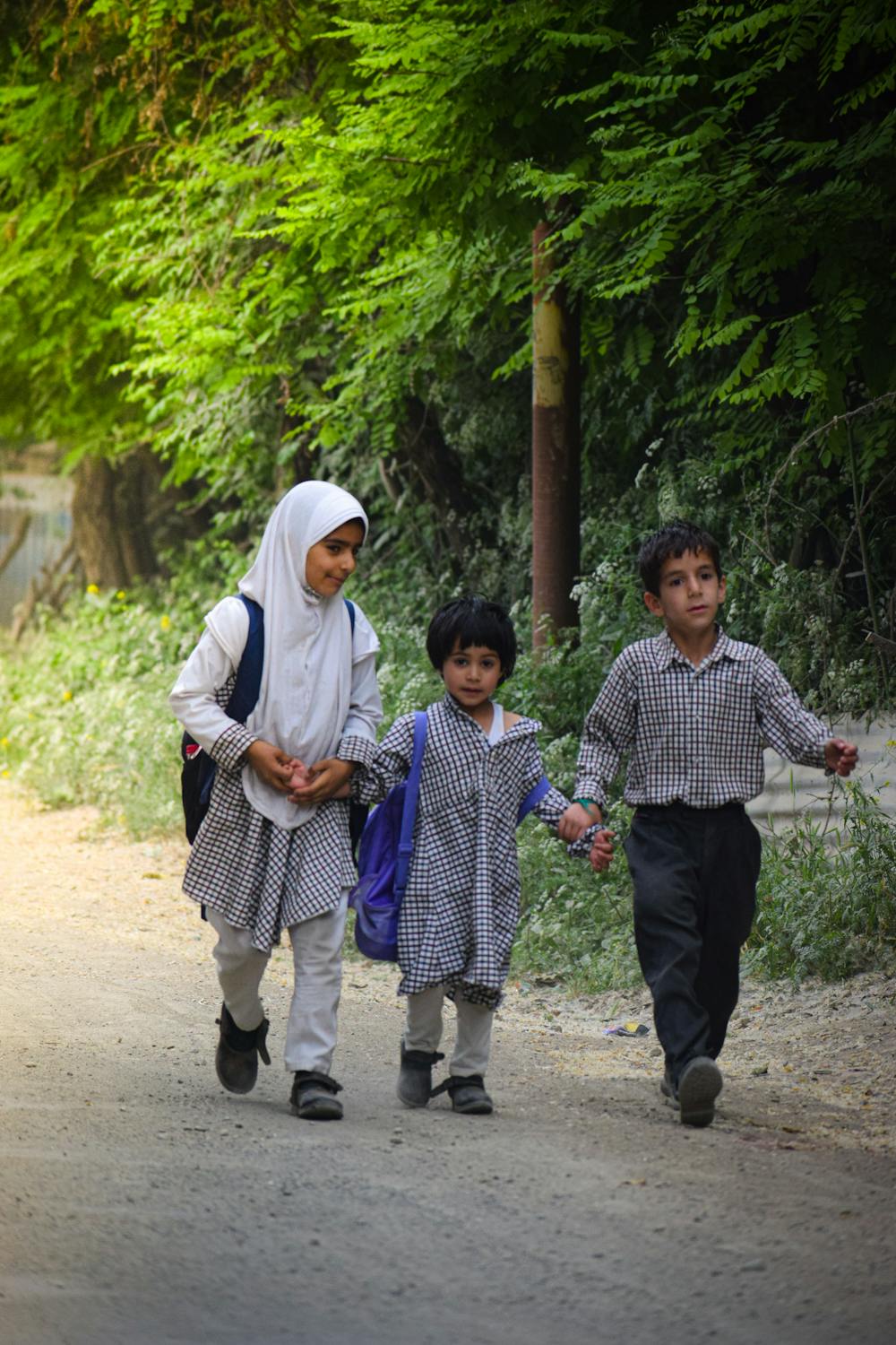 School children walking in neat uniforms with backpacks