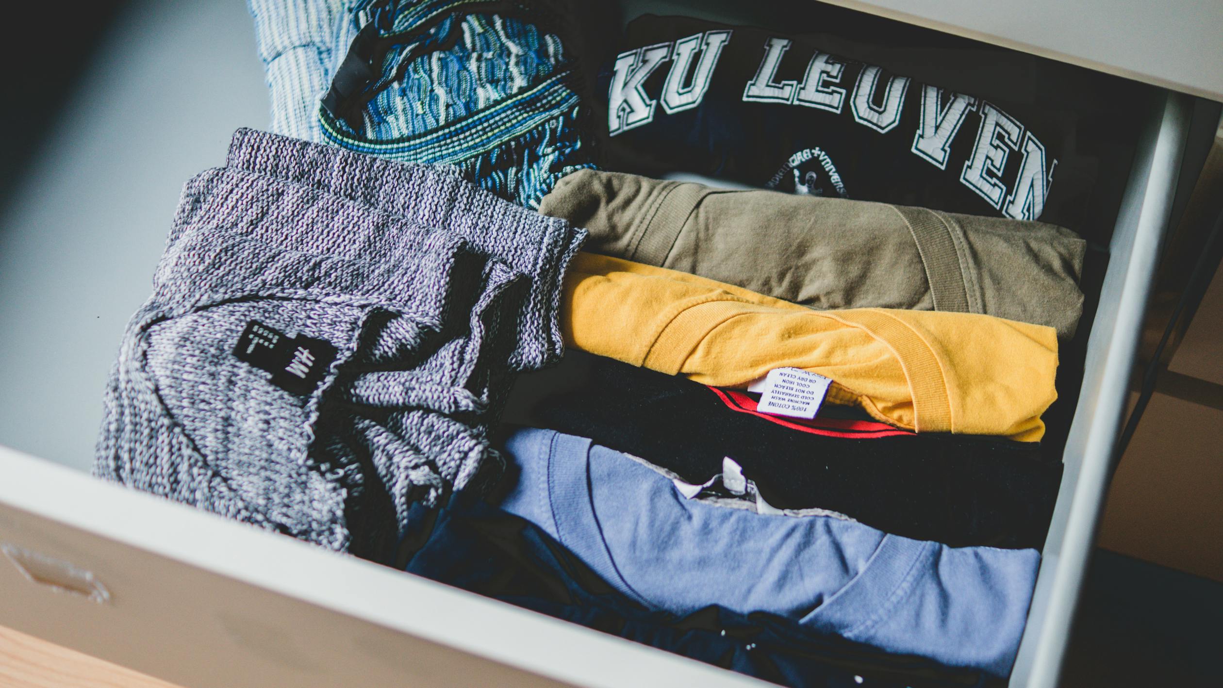 Neatly folded assorted pastel colored shirts for girls capsule wardrobe