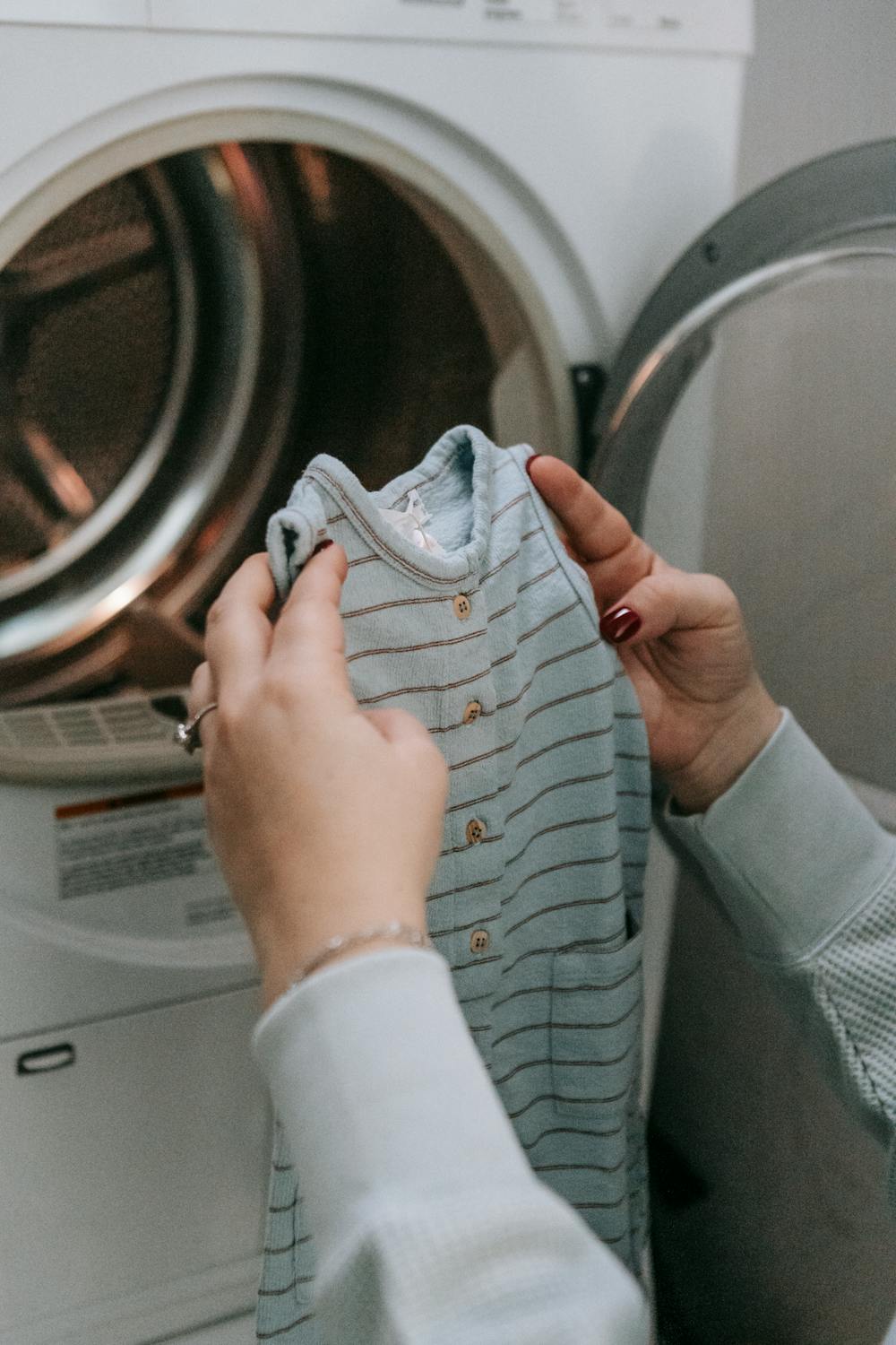 Woman doing gentle laundry to make kids clothes last longer