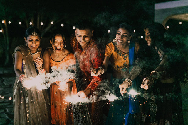 Happy people holding sparklers during Diwali festival celebration