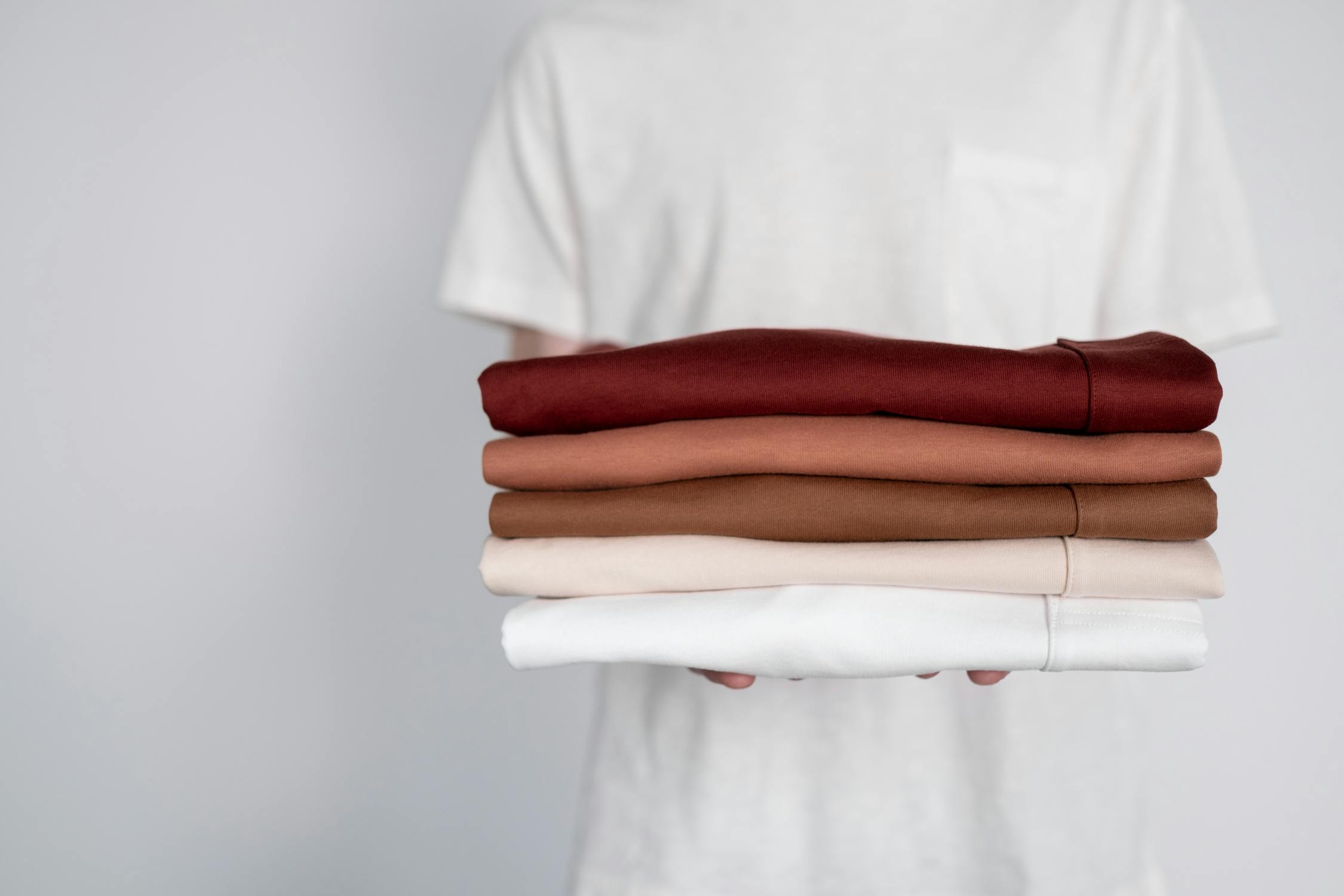 Person holding folded organic textile with natural certification label